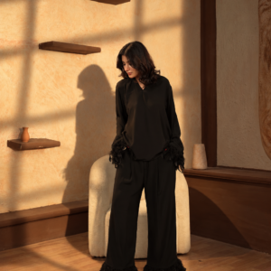Editorial portrait in noir and gold ensemble